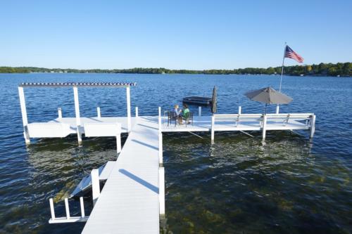 Classic pier with flag pole, umbrella, and kayak rack