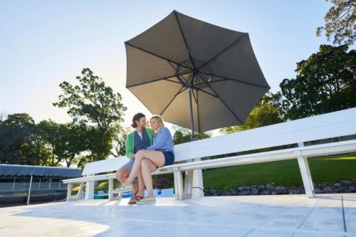 Classic pier with a couple on a bench with an umbrella