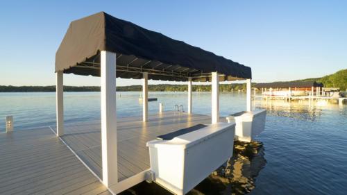 Classic pier with fixed boat canopy and dock boxes